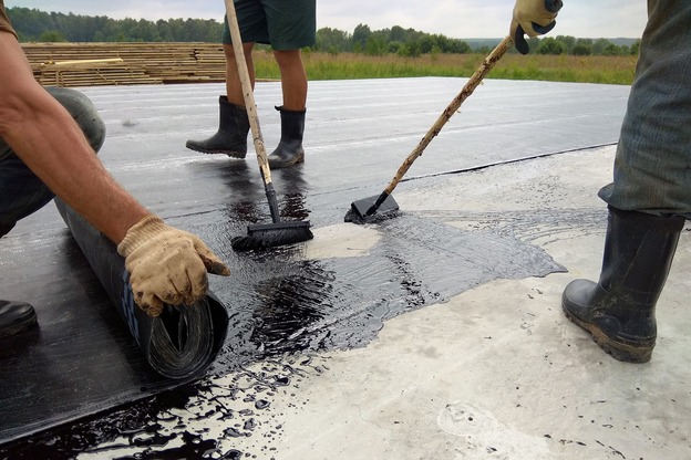 roofer-worker-painting-bitumen-praimer-concrete-surface-by-roller-brush-waterproofing-ezgif.com-resize